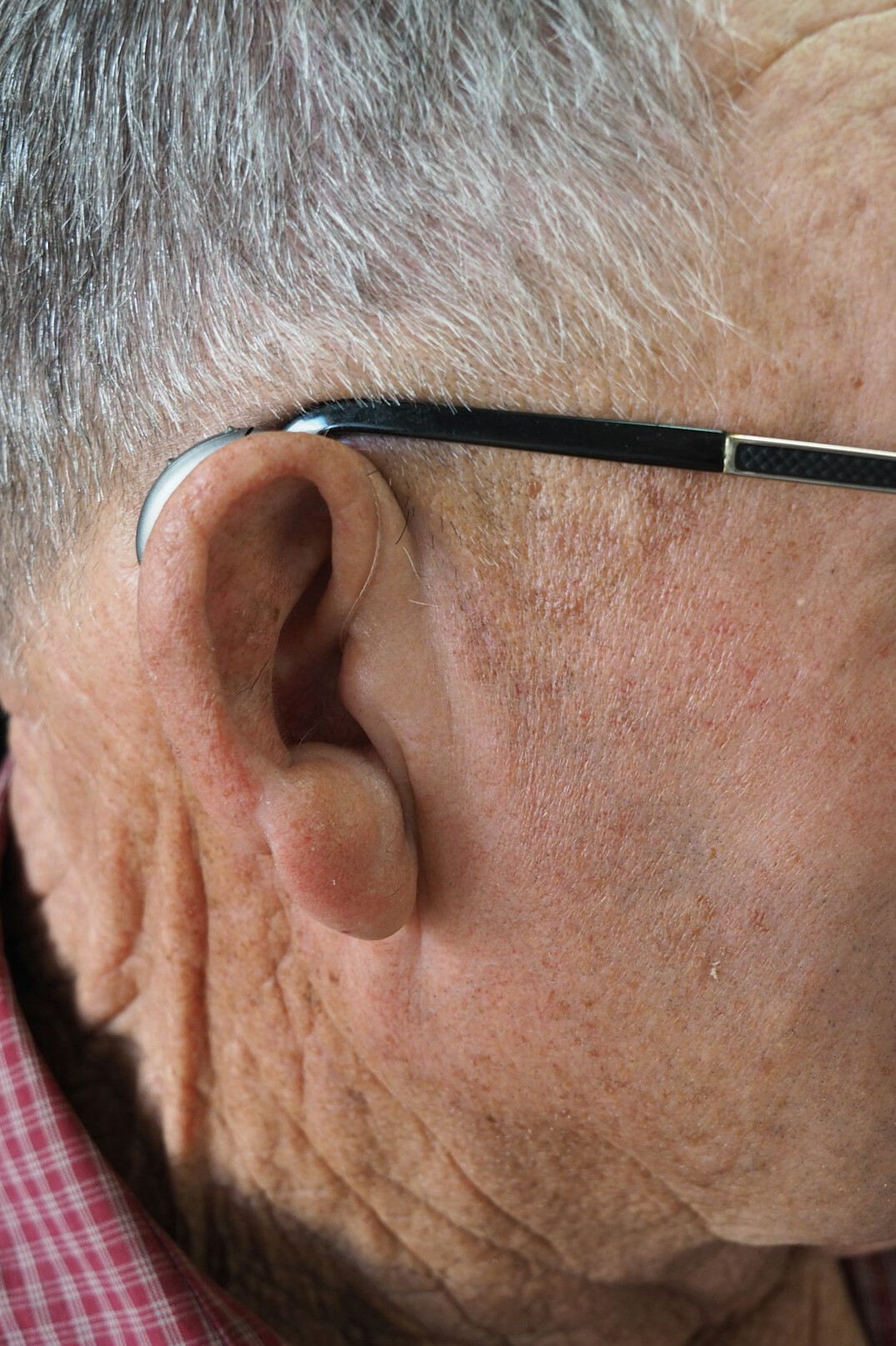 Portrait of an older man head of nursing with grey hair and glasses