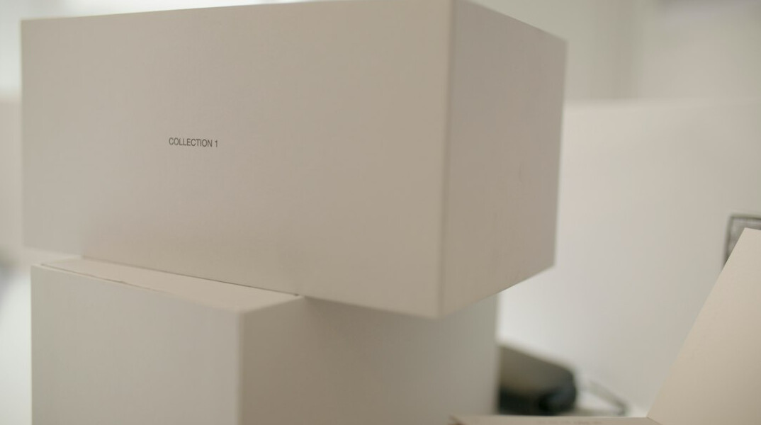 Medical reference books, laptop and anatomical model on a wooden table seen from above